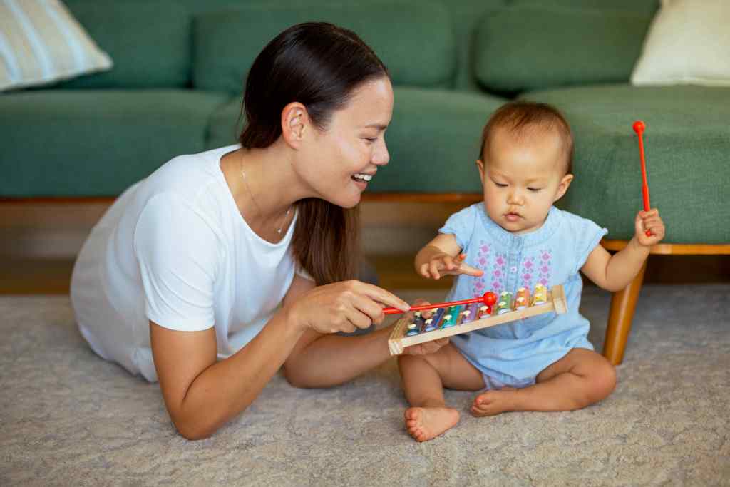 mother playing zylophone with baby